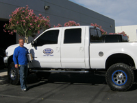 Custom Wrought Iron Gates, Doors, Fences, Art and Rails by Olson Iron Inc., Las Vegas, Nevada.  Picture of Gary Olson with Olson Iron Company Truck.