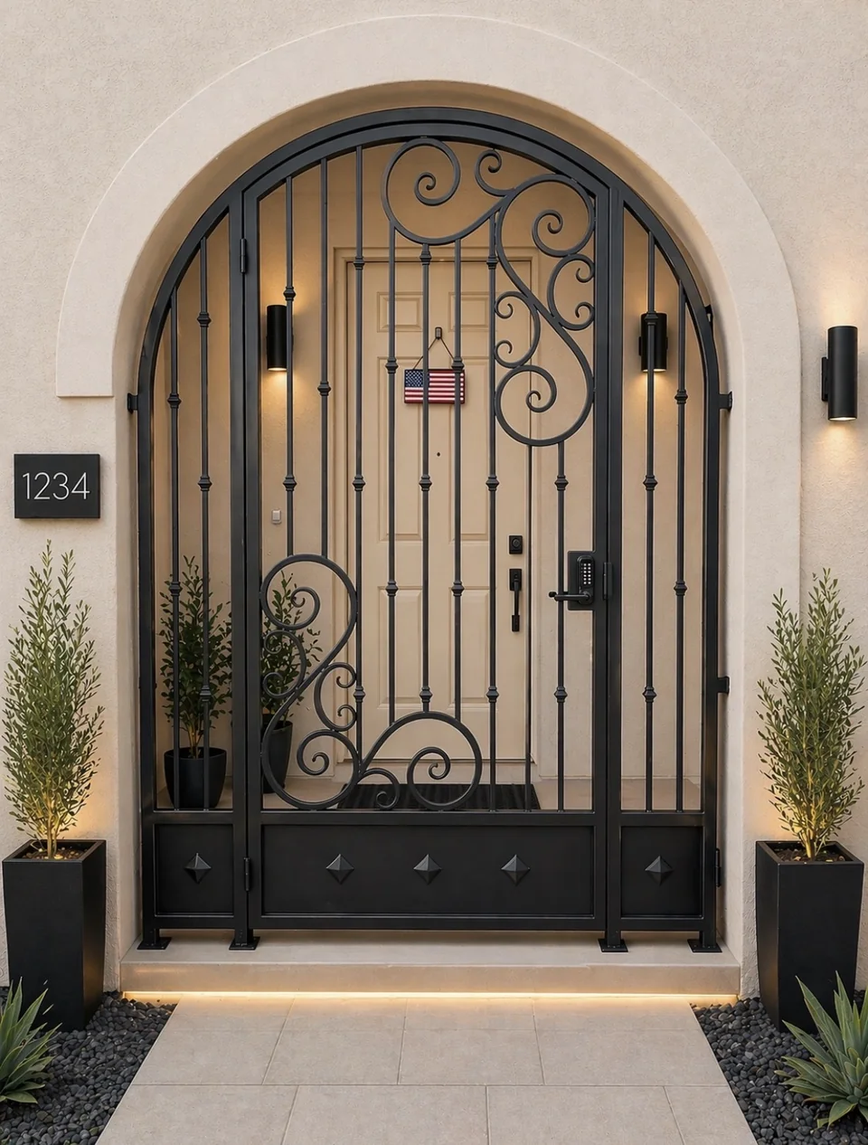 Olson Iron custom courtyard entry gate in Las Vegas — Arched scroll iron entry gate with center scroll medallion and code lock at warm-stucco arched courtyard (921G)